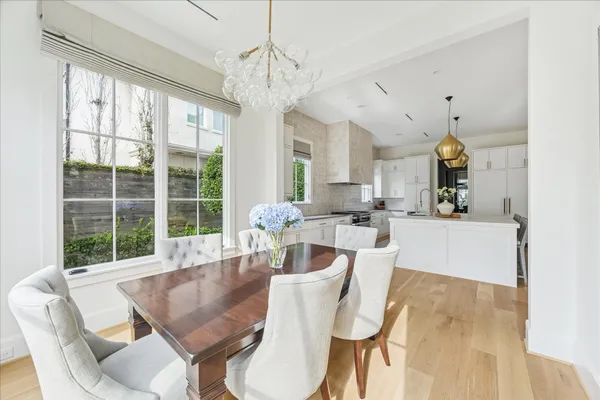 a dining room with furniture a chandelier and wooden floor
