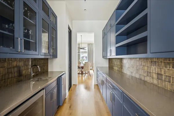 a kitchen with stainless steel appliances granite countertop a lot of counter space and wooden floors