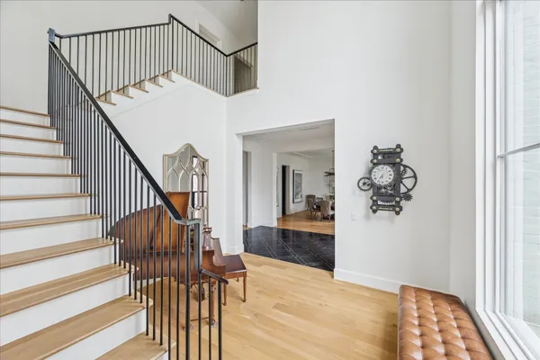 a view of entryway and hall with wooden floor