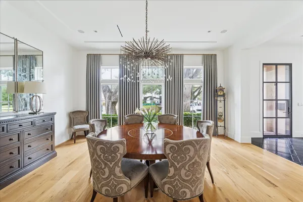 a living room with furniture a large window and wooden floor