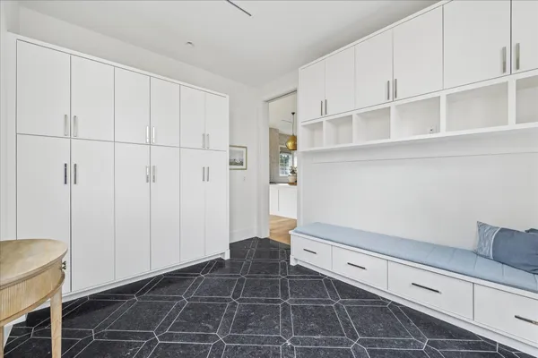 a room with white cabinets and utility room