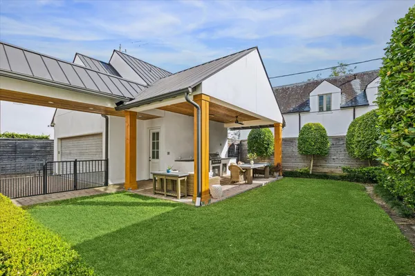 a view of a chair and table in backyard of the house