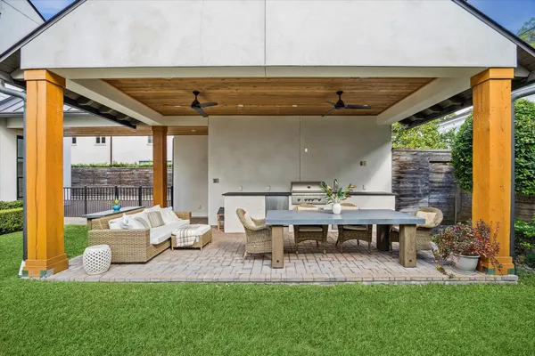 a view of yard from deck with patio