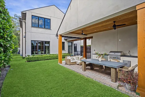 a backyard of a house with table and chairs