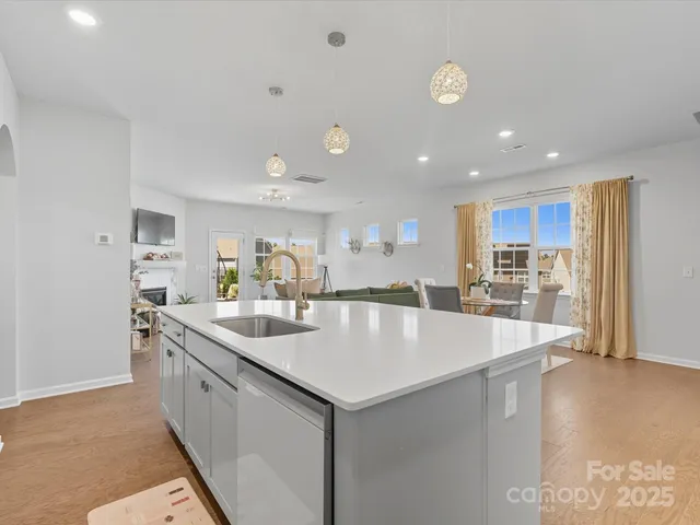 a large kitchen with kitchen island a sink appliances and a counter space