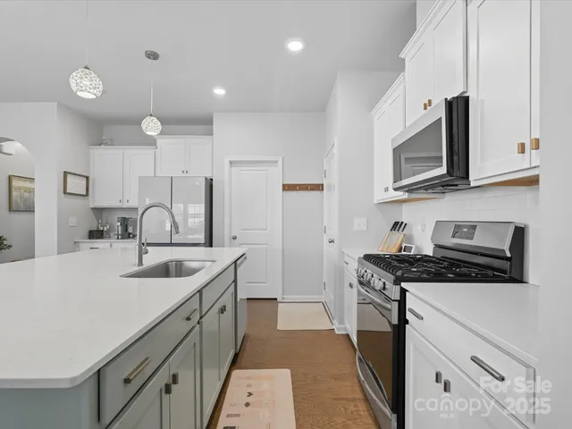 a kitchen that has a sink and a stove