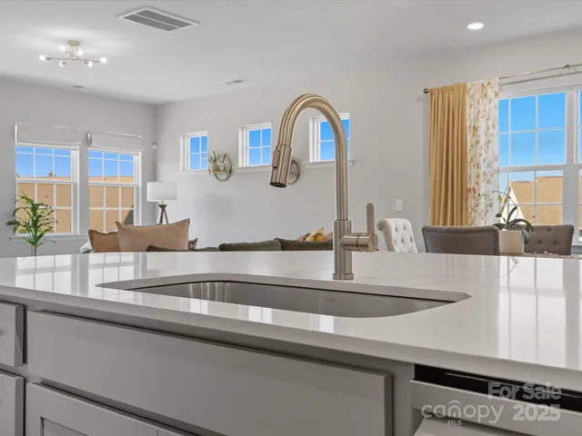 a kitchen with stainless steel appliances granite countertop a sink and a refrigerator