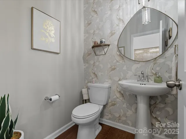 a bathroom with a toilet a sink and mirror