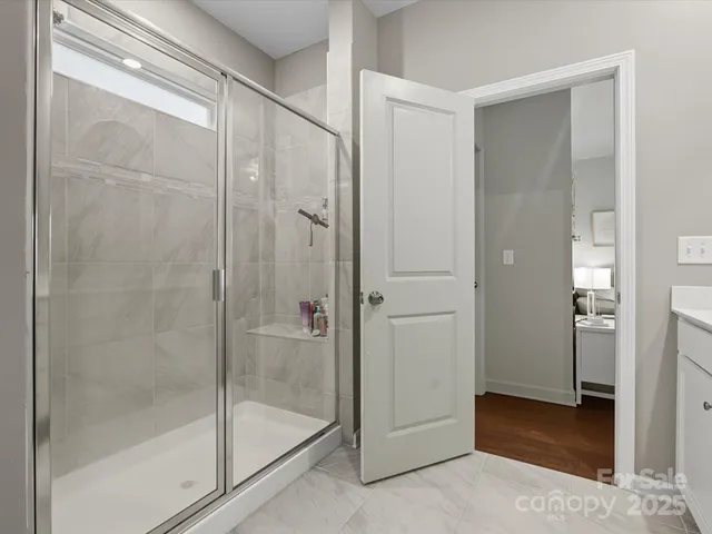 a bathroom with a glass shower door