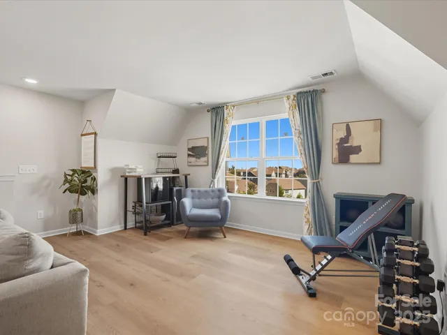 a view of a livingroom with workspace and a window