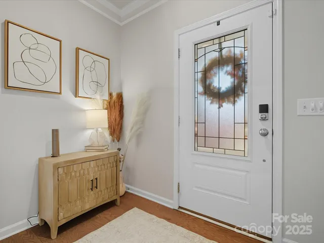 a room that has a dresser and paintings on the wall