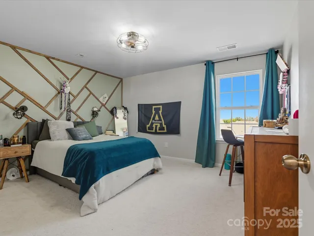 a spacious bedroom with a bed and a table