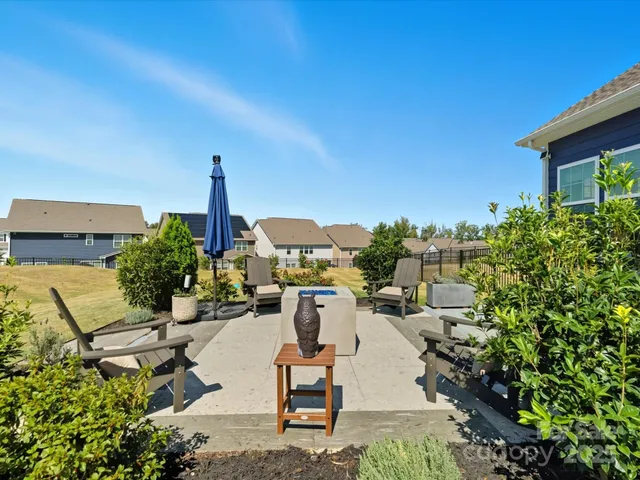 a view of a patio with table and chairs potted plants