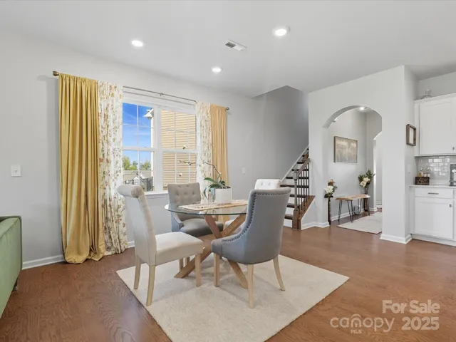 a dining room with furniture and wooden floor