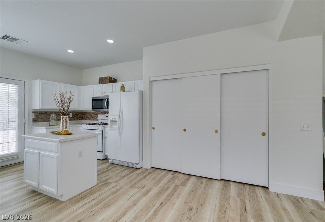 10959 Pumpkin Ridge Avenue Las Vegas, NV 89135 - Photo 39 of 51 A well-appointed kitchen with white cabinetry and an island offers ample space for culinary endeavors.