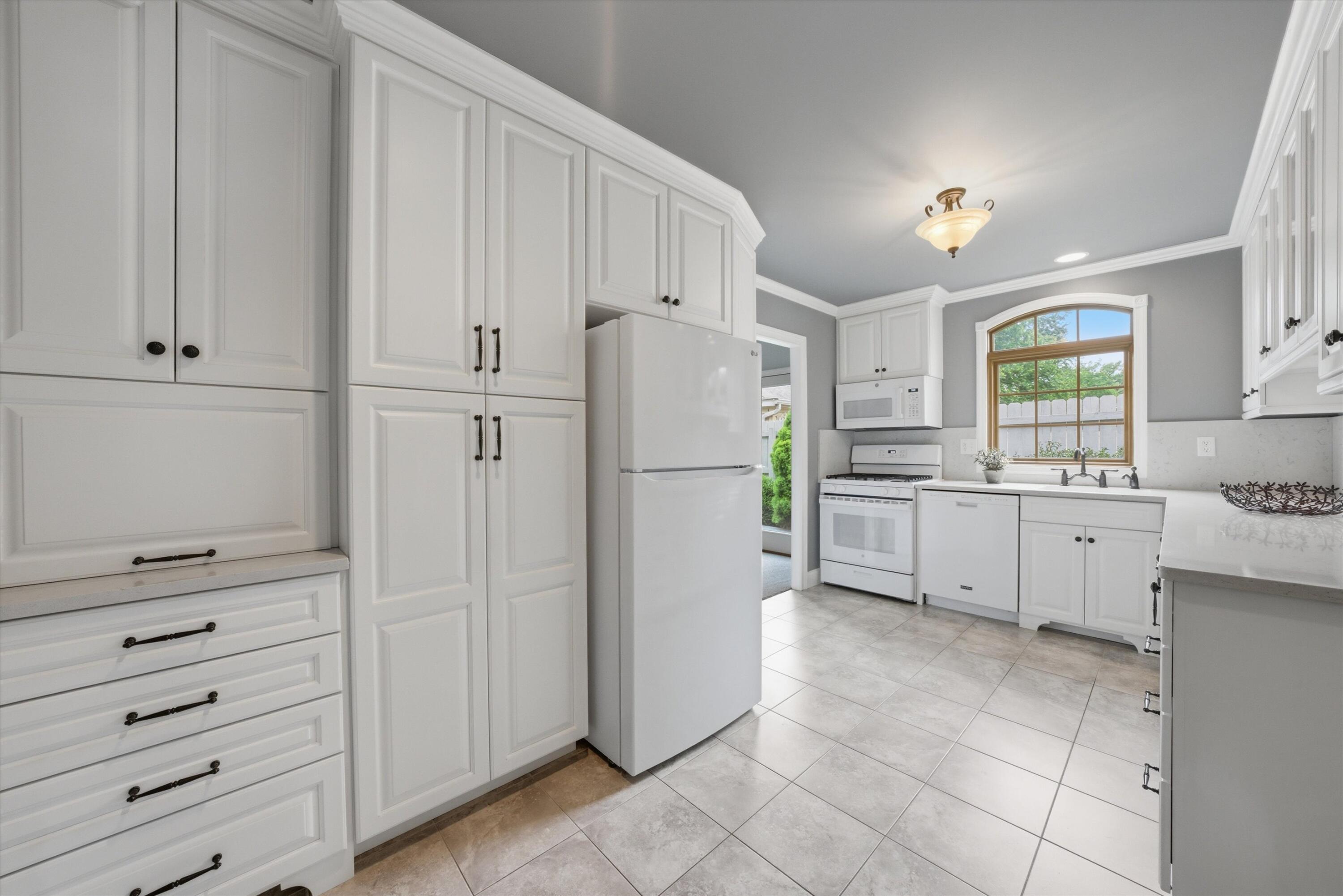 1034 North Indiana Street Griffith, IN 46319 - Photo 3 of 17 a kitchen with white cabinets and white appliances