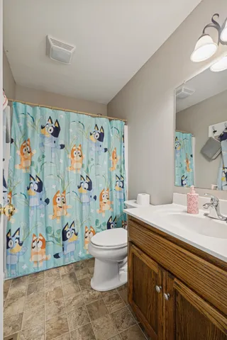 a bathroom with a sink mirror vanity and toilet