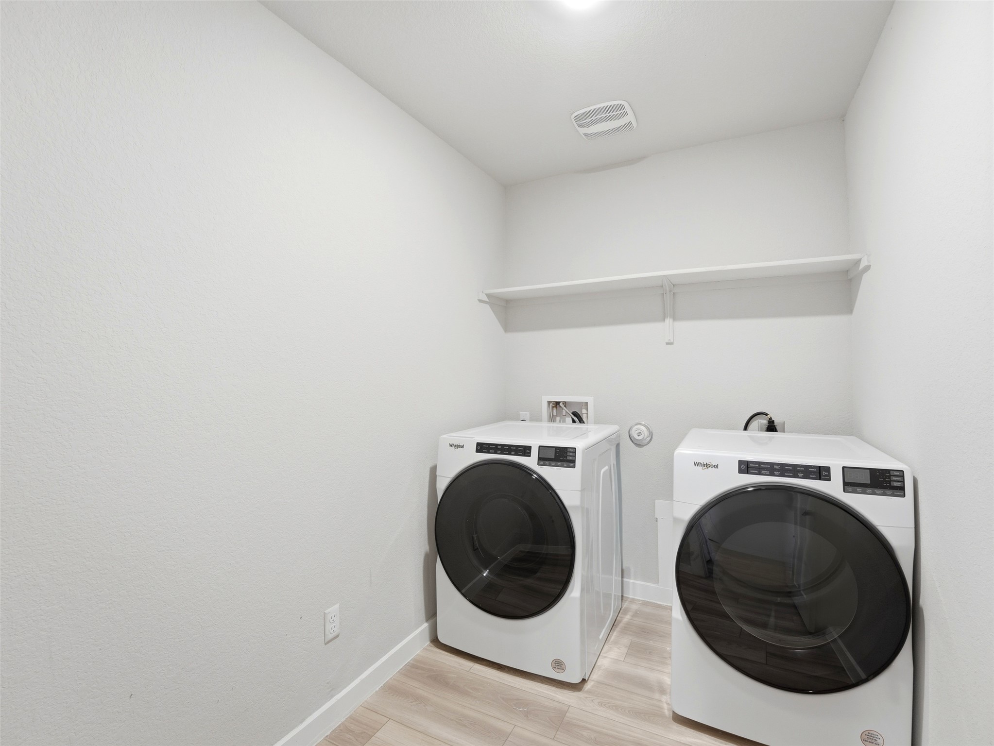 1024 Tipton Street Georgetown, TX 78633 - Photo 26 of 32 Functional laundry space featuring modern appliances and practical shelving for organization.