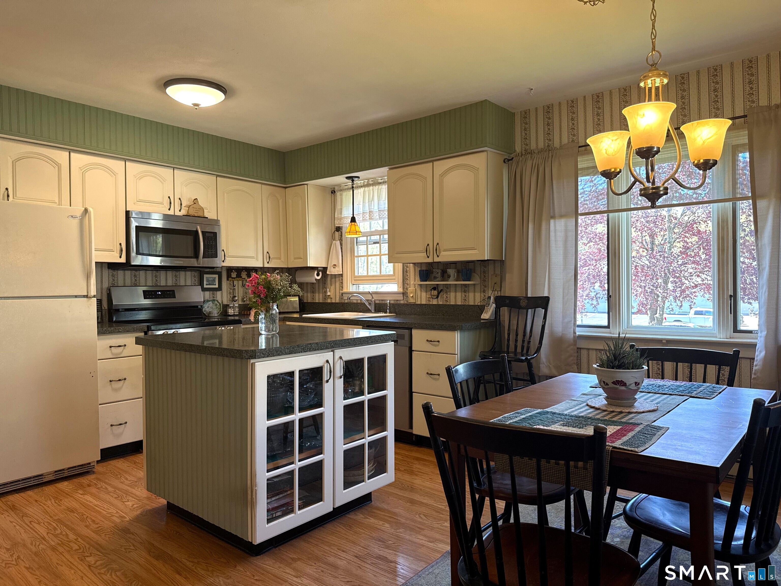 15 Grove Street Deep River, CT 06417 - Photo 6 of 25 a kitchen with stainless steel appliances granite countertop a stove a refrigerator a kitchen island a dining table and chairs
