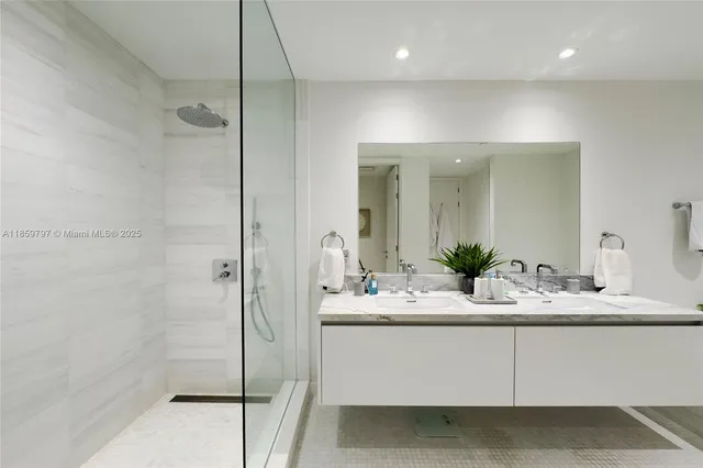 a bathroom with a glass shower door