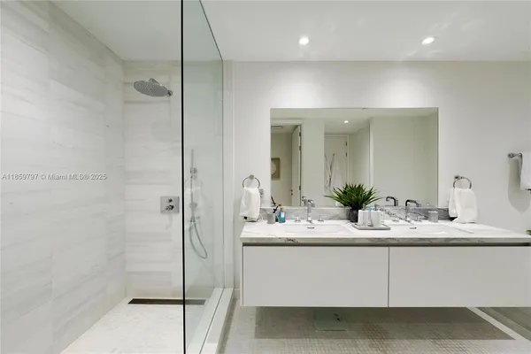 a bathroom with a glass shower door
