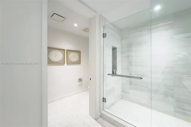 a bathroom with a granite countertop sink mirror and shower