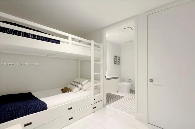 a en suite bathroom with a sink a toilet and a mirror