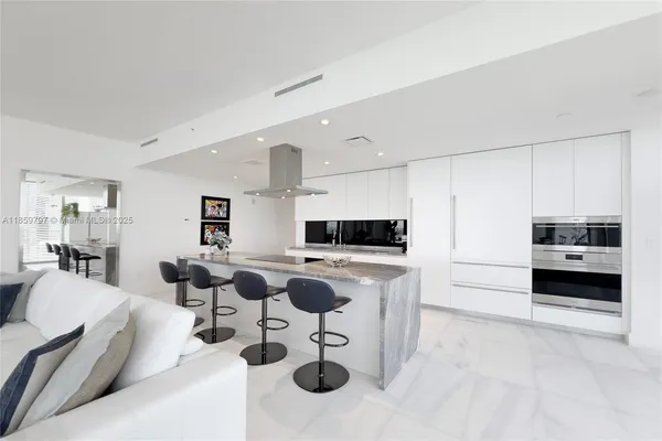 a large white kitchen with a large window
