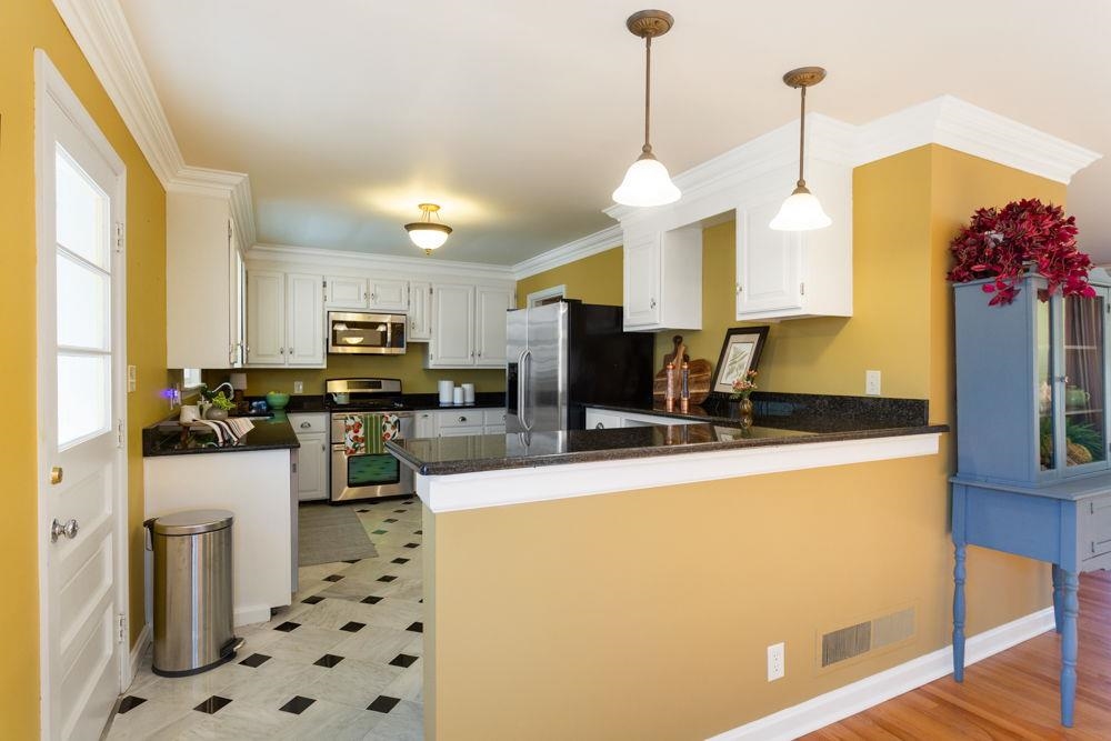 210 Edgewood Road Staunton, VA 24401 - Photo 12 of 41 a kitchen with stainless steel appliances kitchen island granite countertop a sink a stove and refrigerator