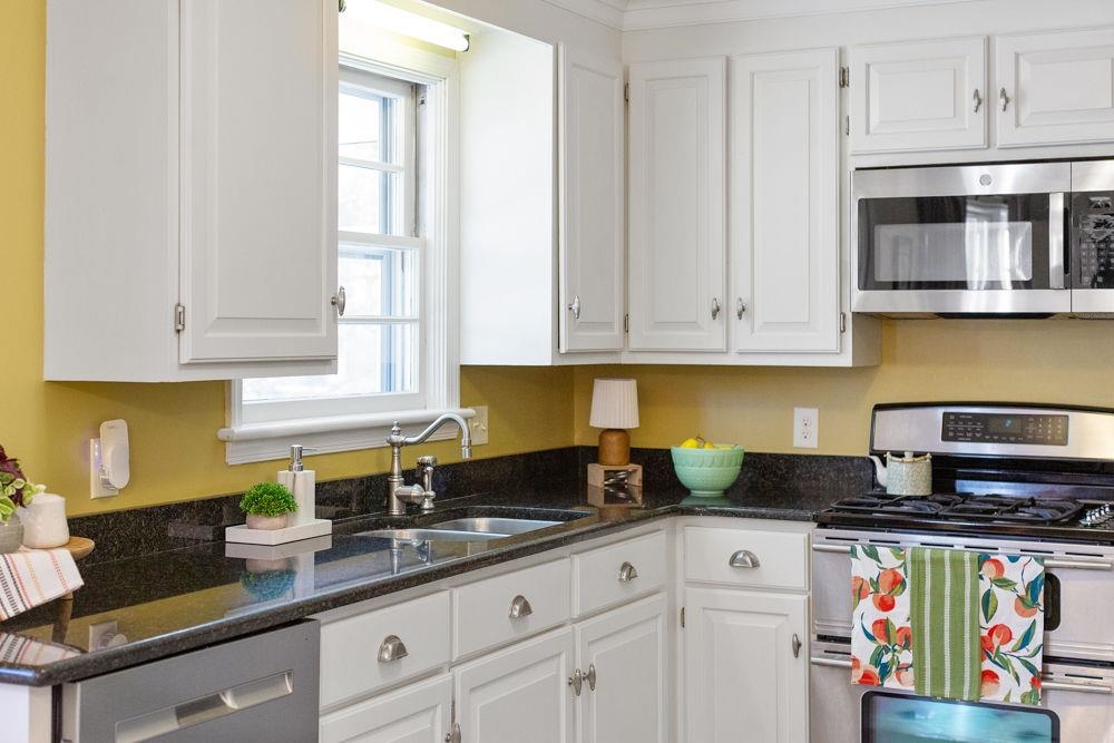 210 Edgewood Road Staunton, VA 24401 - Photo 15 of 41 a kitchen with stainless steel appliances granite countertop a stove a sink and white cabinets