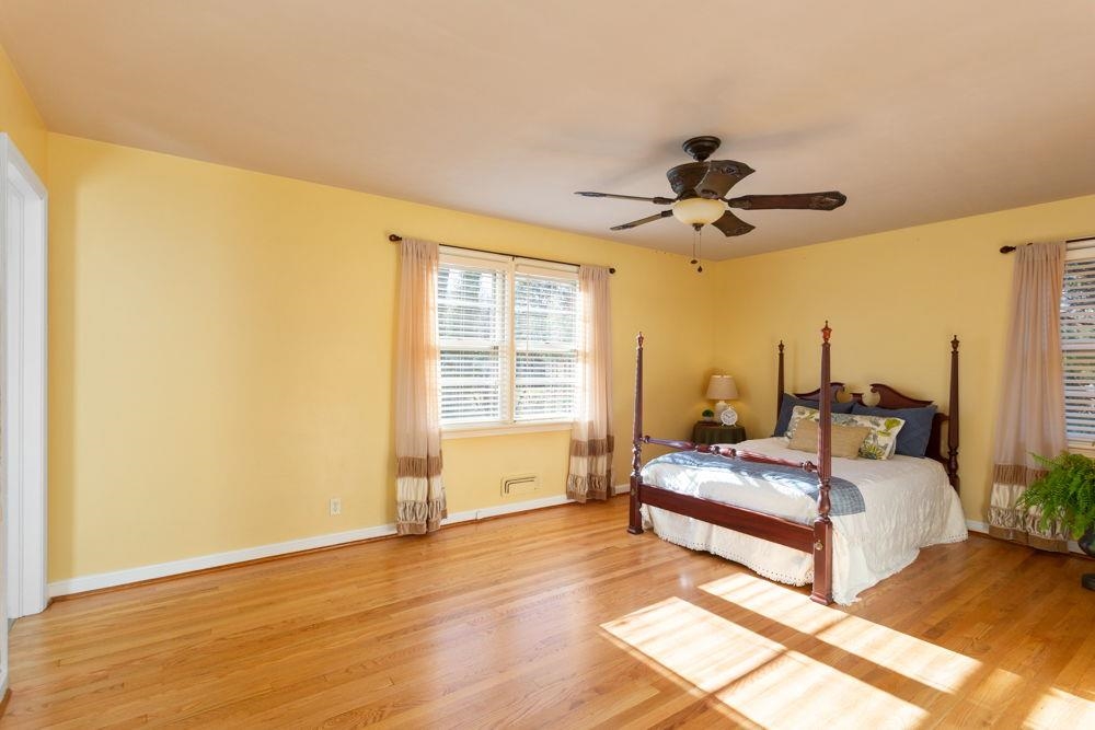 210 Edgewood Road Staunton, VA 24401 - Photo 23 of 41 a spacious bedroom with a bed and a chandelier