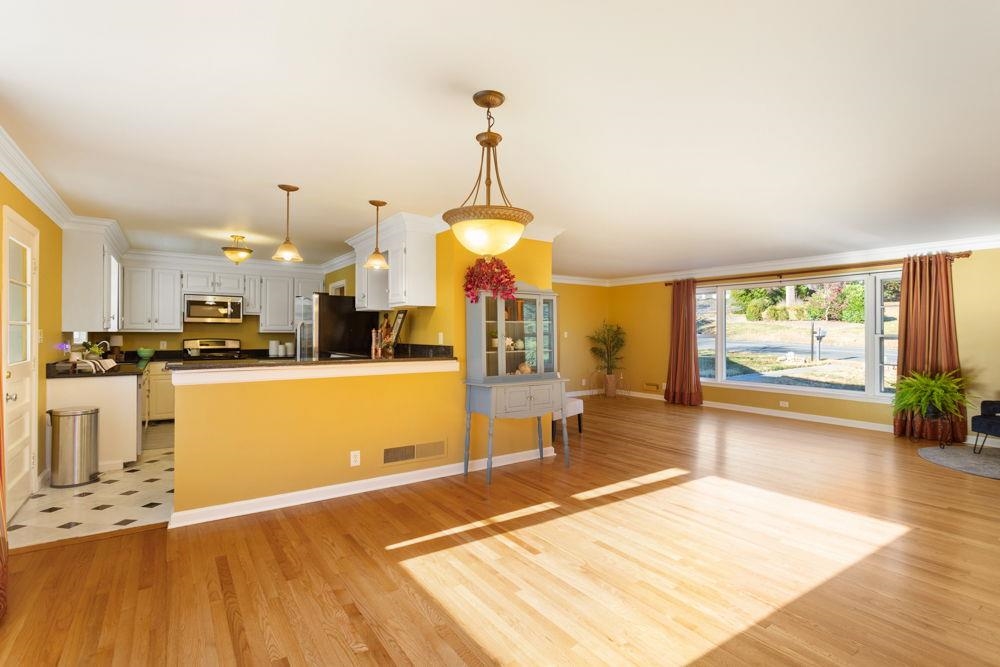 210 Edgewood Road Staunton, VA 24401 - Photo 9 of 41 a living room with stainless steel appliances kitchen island granite countertop a dining table chairs and a large window