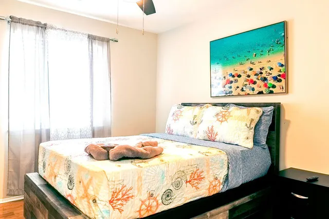 a bedroom with a bed a flat screen tv and a fireplace