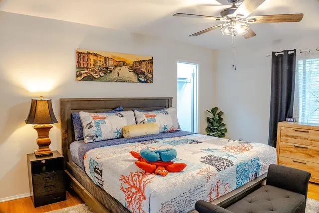 a bedroom with a bed and a painting on the wall