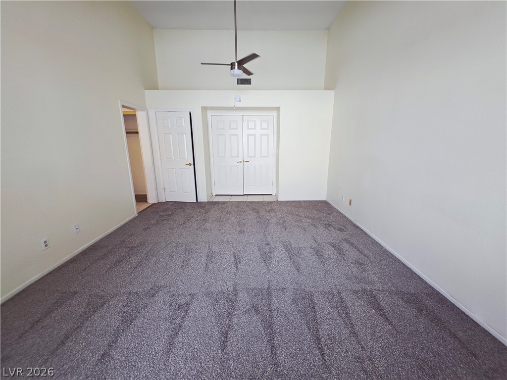 2920 Setting Sun Street Las Vegas, NV 89117 - Photo 25 of 43 This spacious bedroom features a high vaulted ceiling, plush carpet flooring, and abundant natural light.