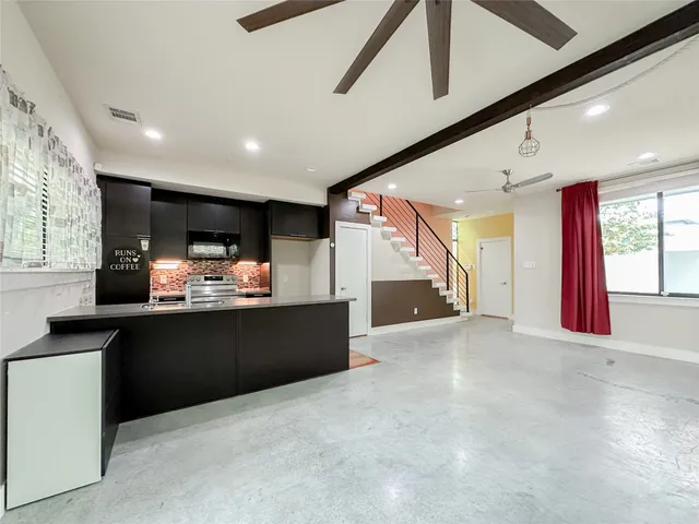 a kitchen with stainless steel appliances granite countertop a refrigerator and a sink