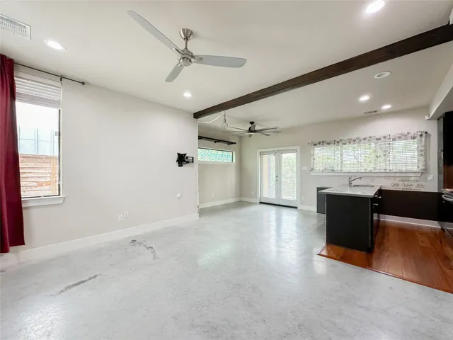 a kitchen with a large window cabinets and stainless steel appliances