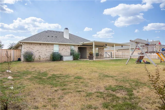 a view of a house with a backyard and a kitchen