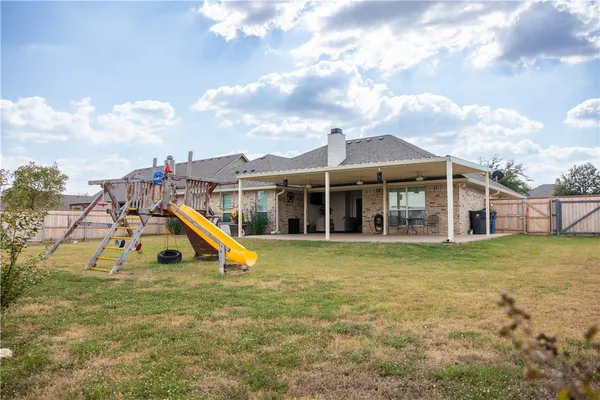 a view of a house with a yard and sitting area