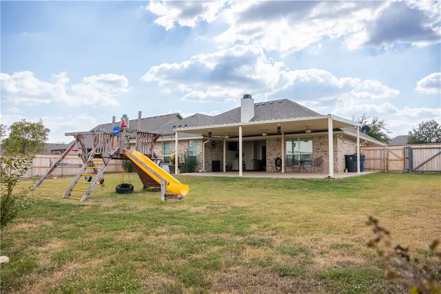 a view of a house with a yard and sitting area