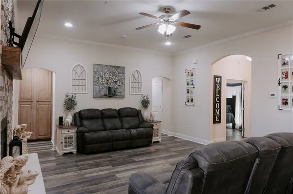 a living room with furniture and a wooden floor
