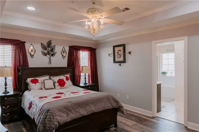 a bedroom with a large bed and a chandelier