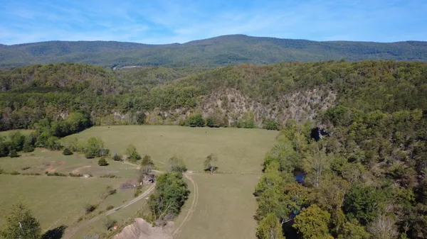 a view of a field with a mountain in the background