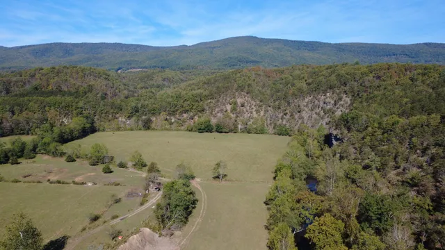 a view of a field with a mountain in the background