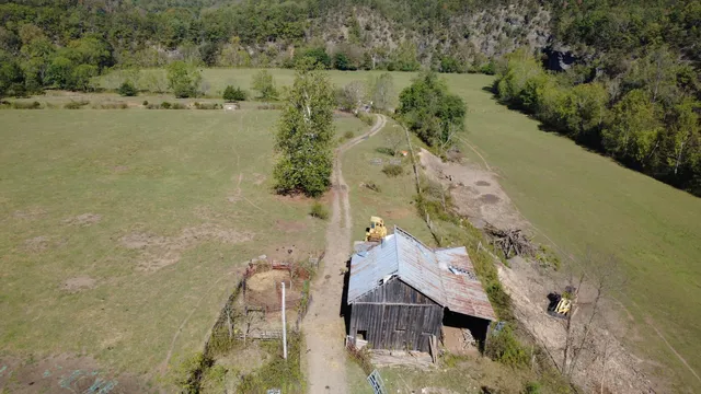 an aerial view of a house with a yard and lake view