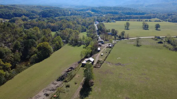 an aerial view of a house with a yard