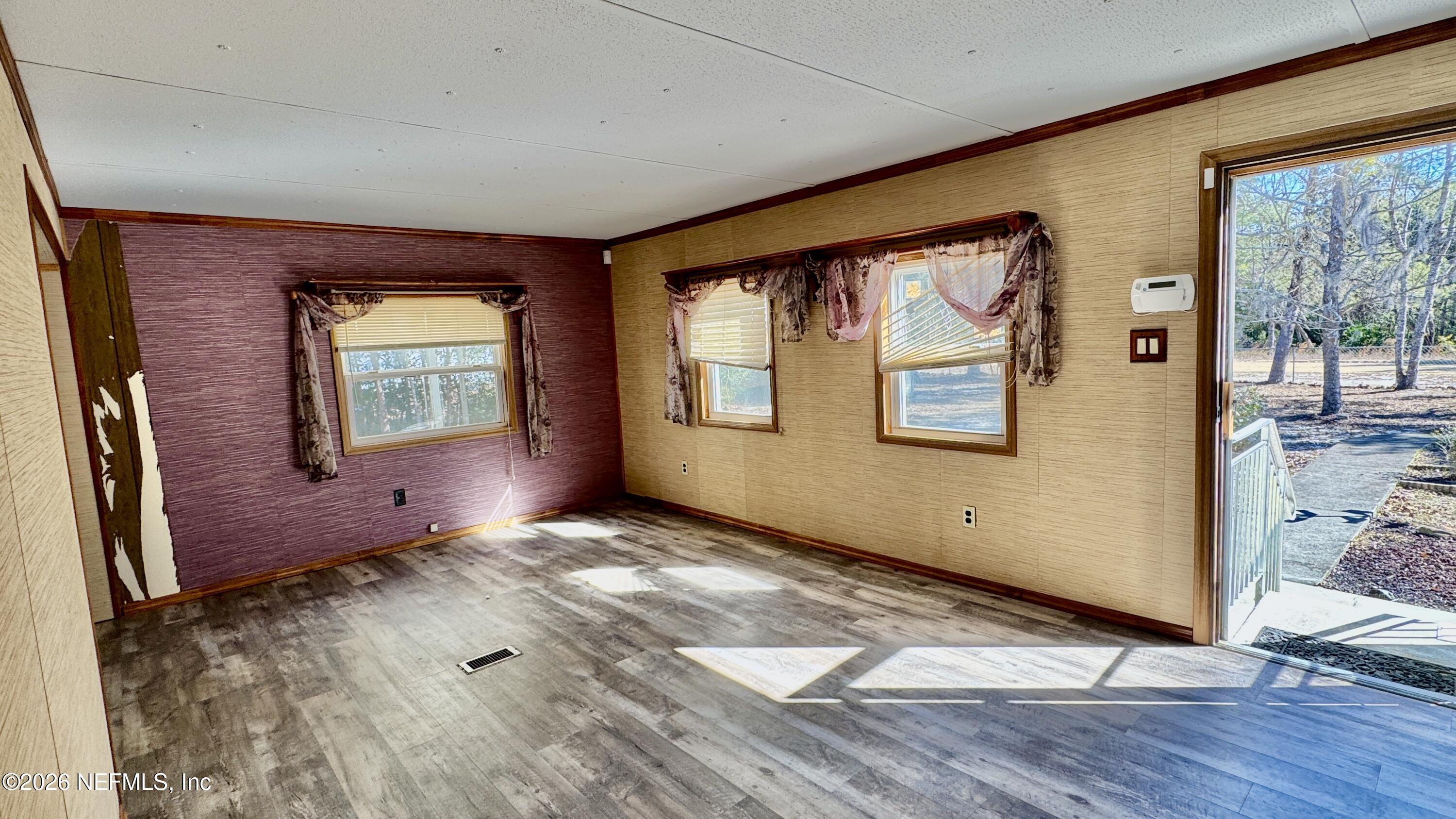 105 Rachel Road Interlachen, FL 32148 - Photo 11 of 24 a view of a livingroom with wooden floor and windows