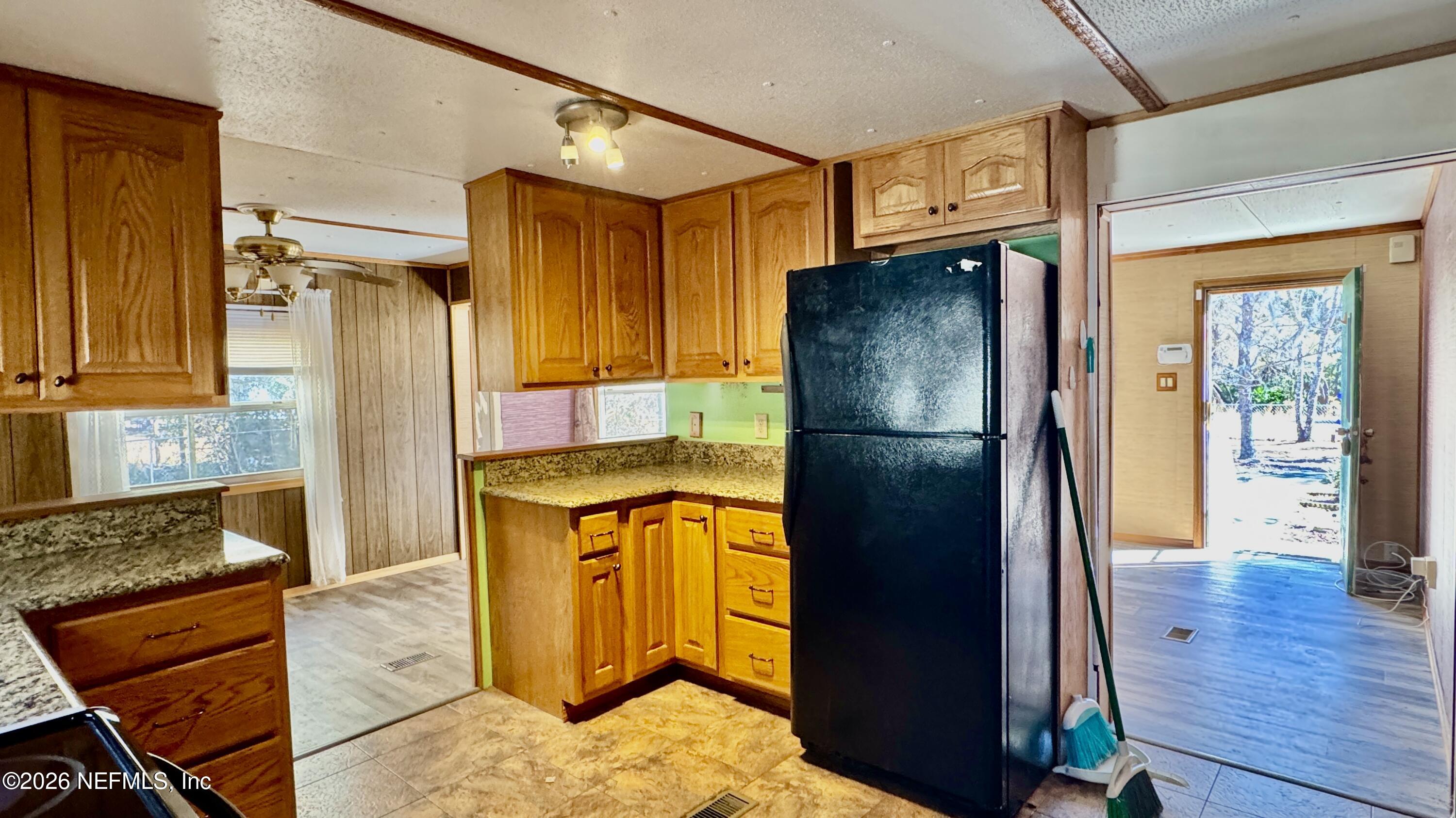 105 Rachel Road Interlachen, FL 32148 - Photo 15 of 24 a kitchen with stainless steel appliances granite countertop a refrigerator and a stove