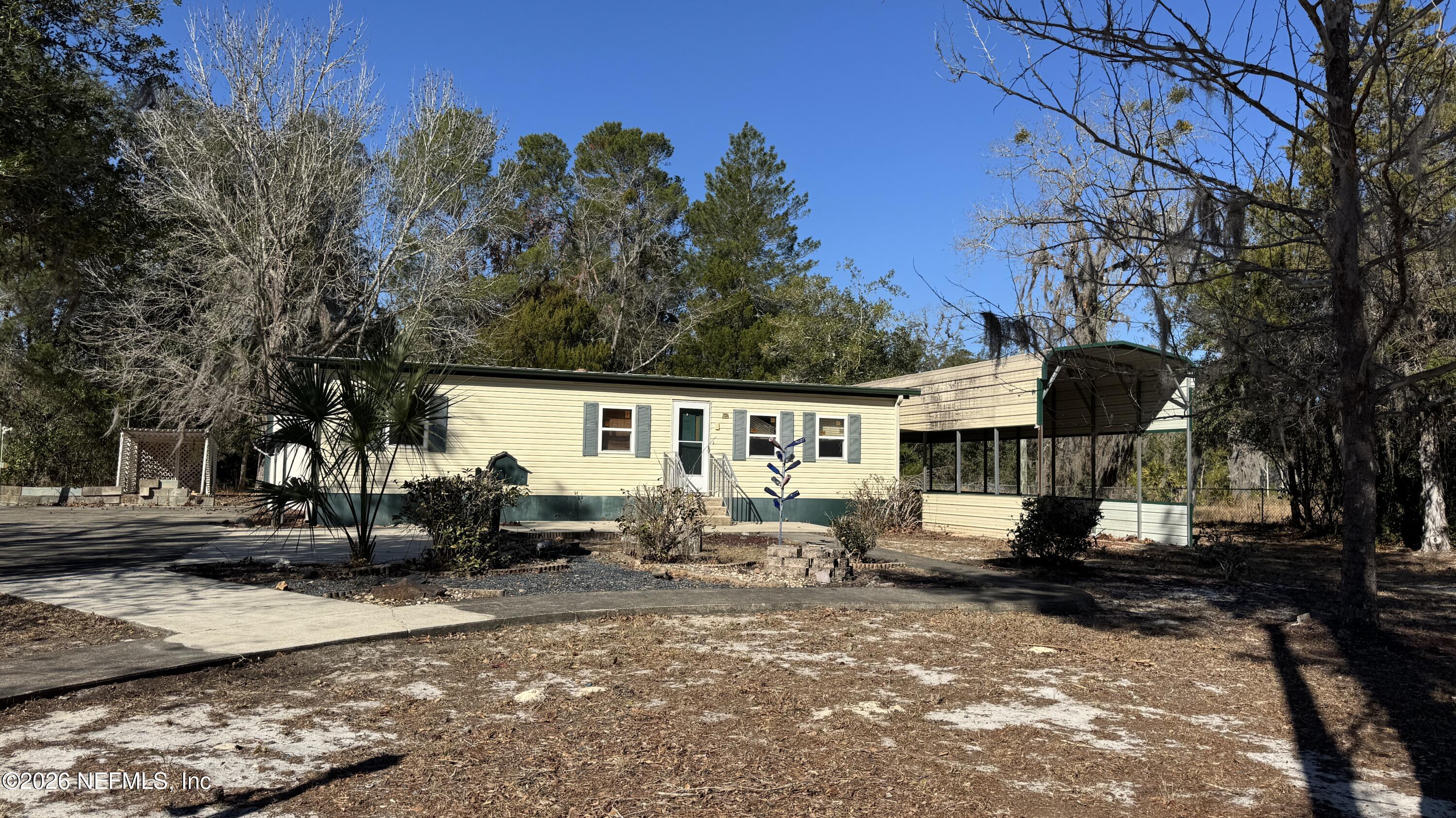 105 Rachel Road Interlachen, FL 32148 - Photo 3 of 24 a backyard of a house with yard fire pit and outdoor seating