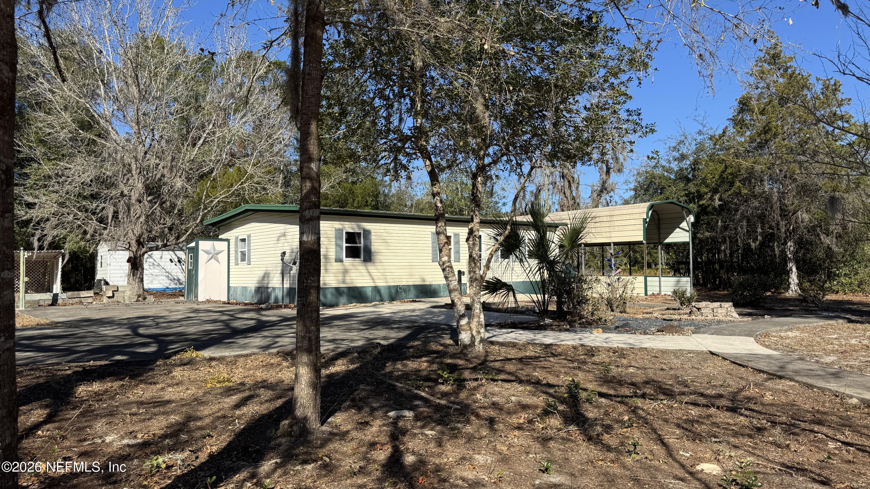 105 Rachel Road Interlachen, FL 32148 - Photo 5 of 24 a view of a street with large trees